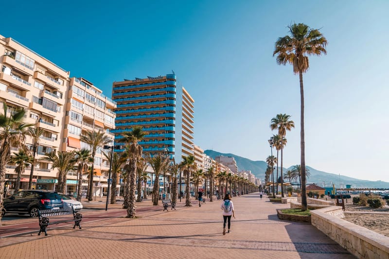 Residents walking along the seafront promenade in Fuengirola