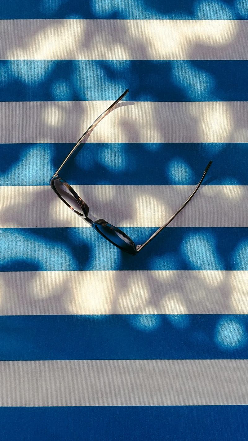 Notebook and glasses in coastal sunlight