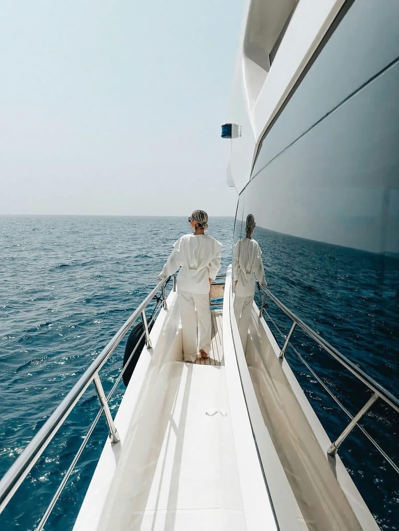 A couple enjoying the coast from a sailboat